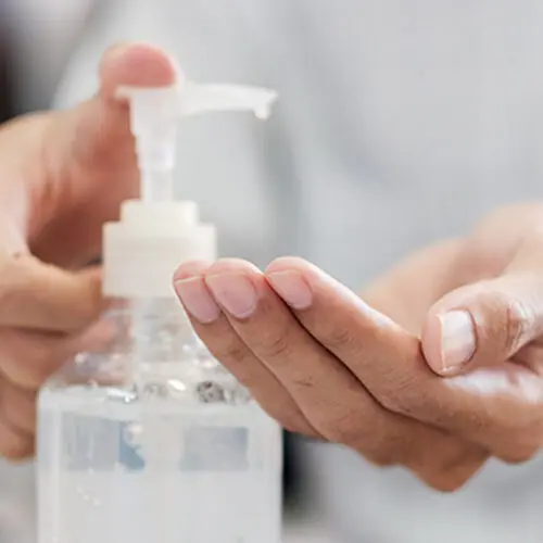 Photograph of hands being washed with sanitiser