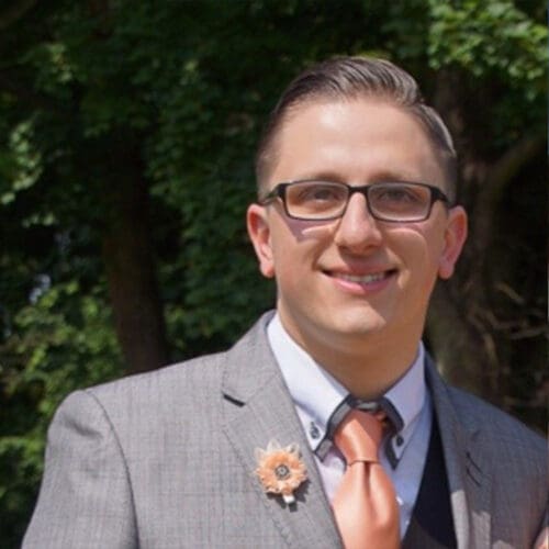 Joe Armstrong-Gore smiling in a suit
