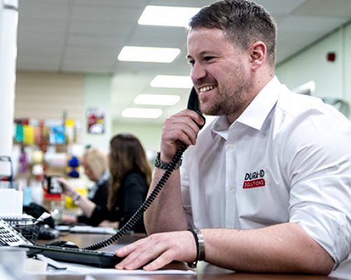 Telephone Support Member of Dura on the phone to a customer